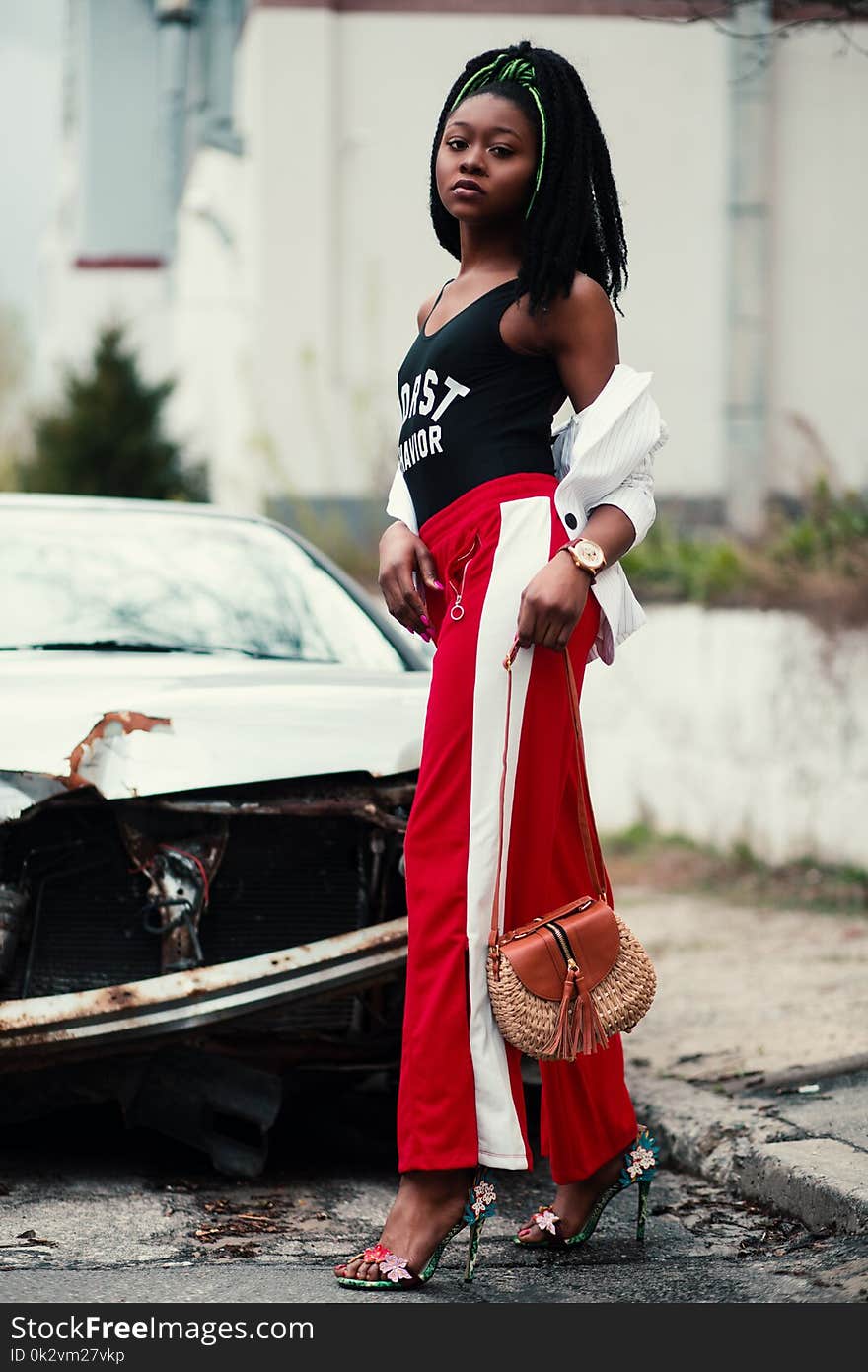 Women&#x27;s Black Tank Top and Red Track Pants Walking on Street