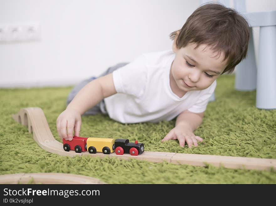 Small Toddler In A Colorful Children Room In A Nursery Or Preschool. Child Boy Playing With Toys Indicators At Home