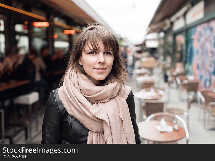 Young tourist girl walks by street. Market in Vienna, Austria.