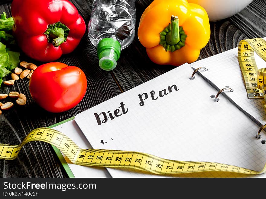 Concept diet and slimming plan with vegetables close up mock up on wooden background. Concept diet and slimming plan with vegetables close up mock up on wooden background