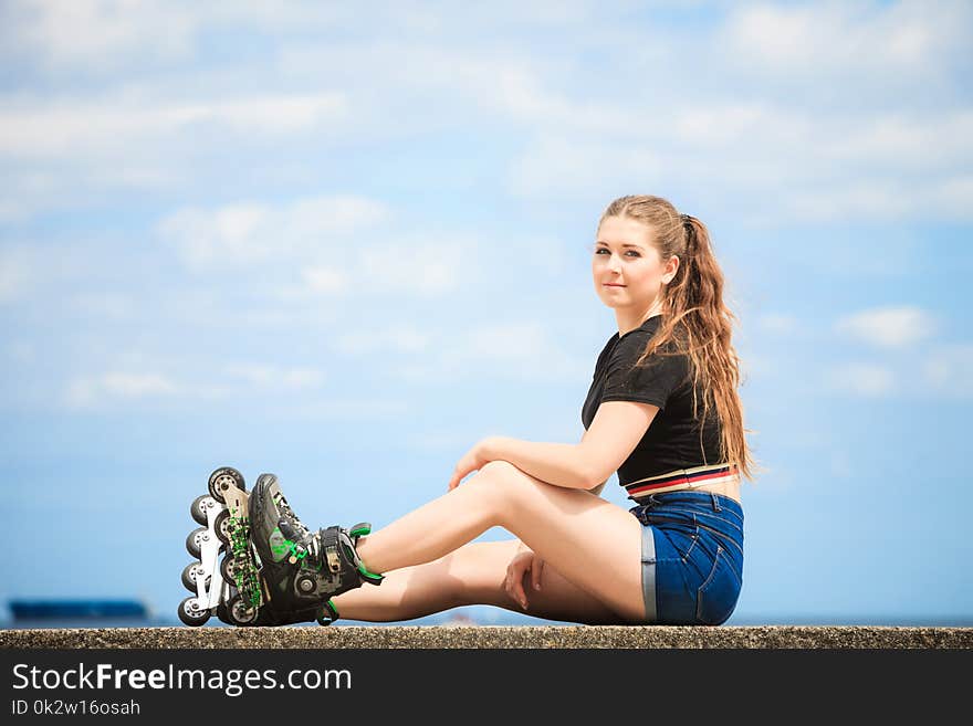 Happy Young Woman Wearing Roller Skates