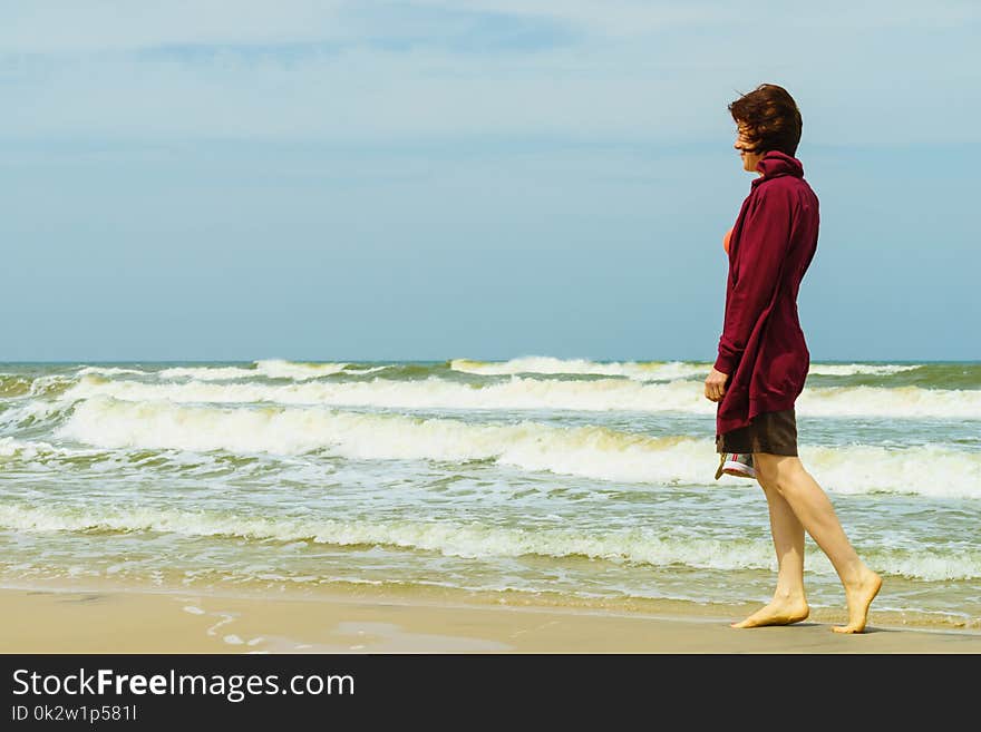 Woman walking on beach