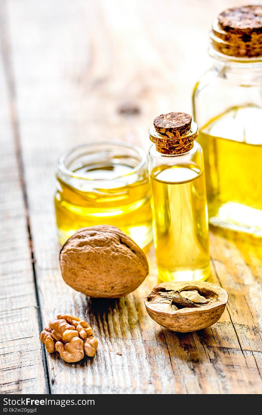 Cosmetic and therapeutic walnut oil on wooden background