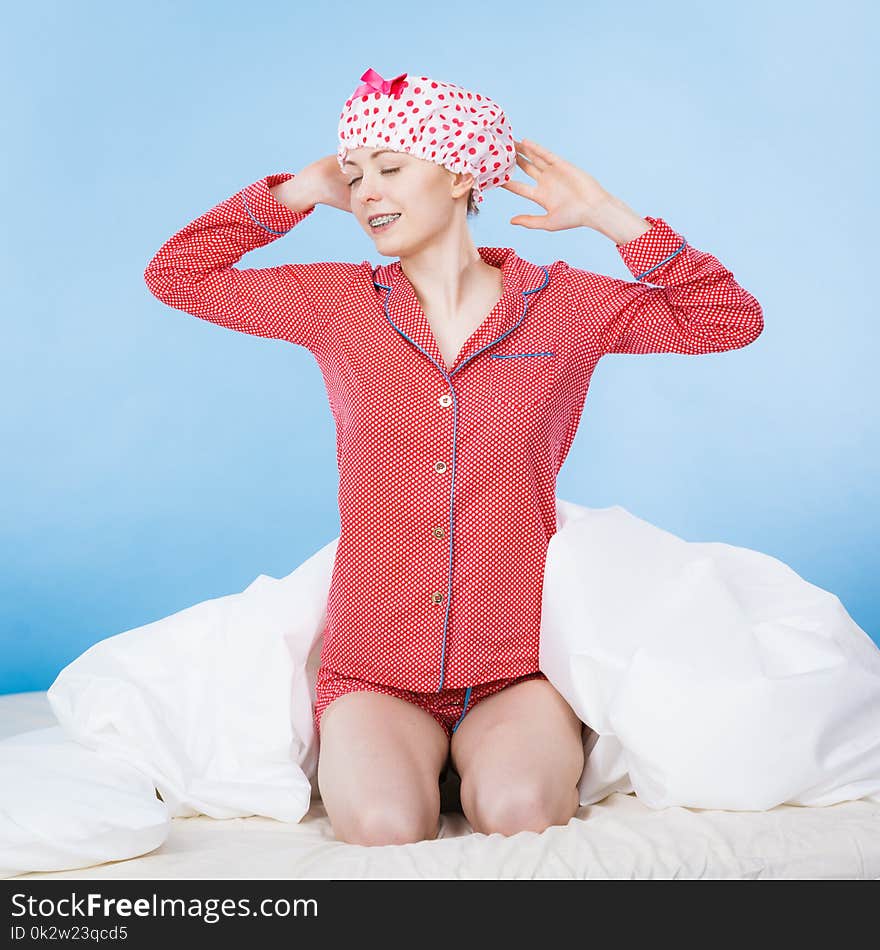 Funny woman wearing pajamas and bathing cap