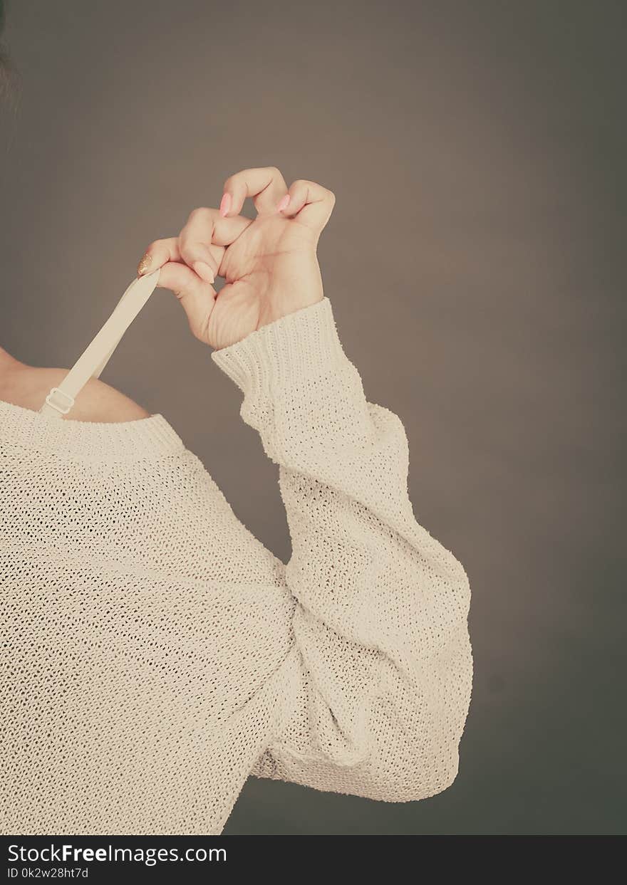 Woman holding her bra strap