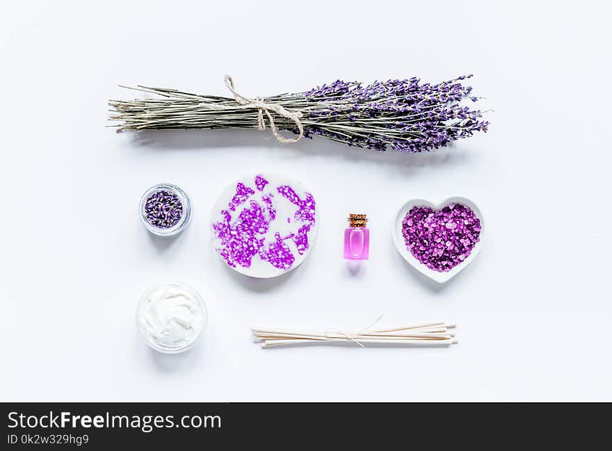 Lavender herbs in body care cosmetics on white table background top view space for text. Lavender herbs in body care cosmetics on white table background top view space for text