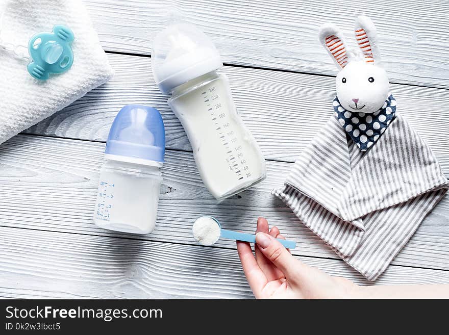 Preparation of mixture baby feeding on wooden background top view.