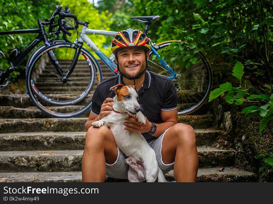 Male Posing With His Russel Dog On Stairs.