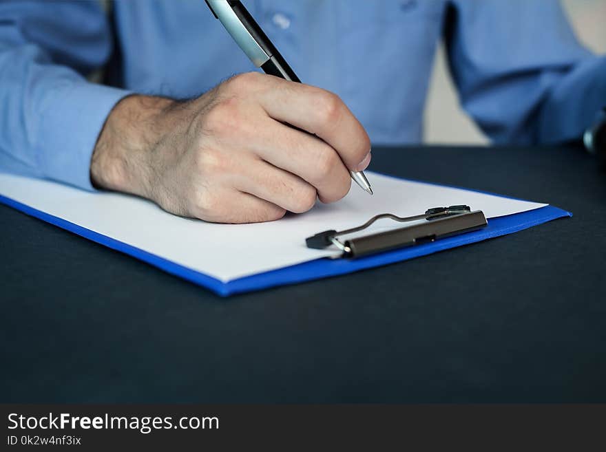 Man writing on a blank paper. Business concept