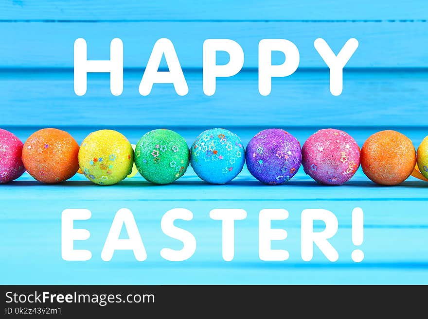 Colorful easter egg on blue pastel color wood background with space. Happy easter.