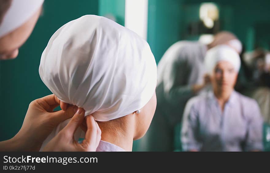 Two Muslim Women To Tie Islamic Turban, Preparing For A Wedding Near Mirror