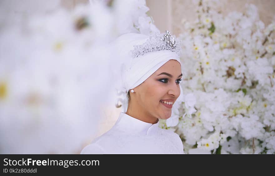 Smiling muslim bride with bridal make up in flowers