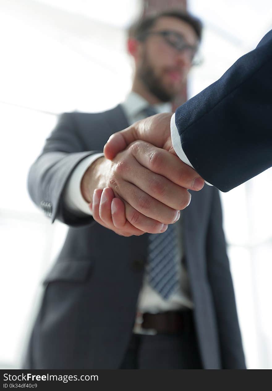 Business leader shaking hands with partner.