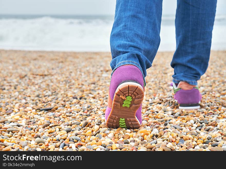 Woman Walking On The Beach.