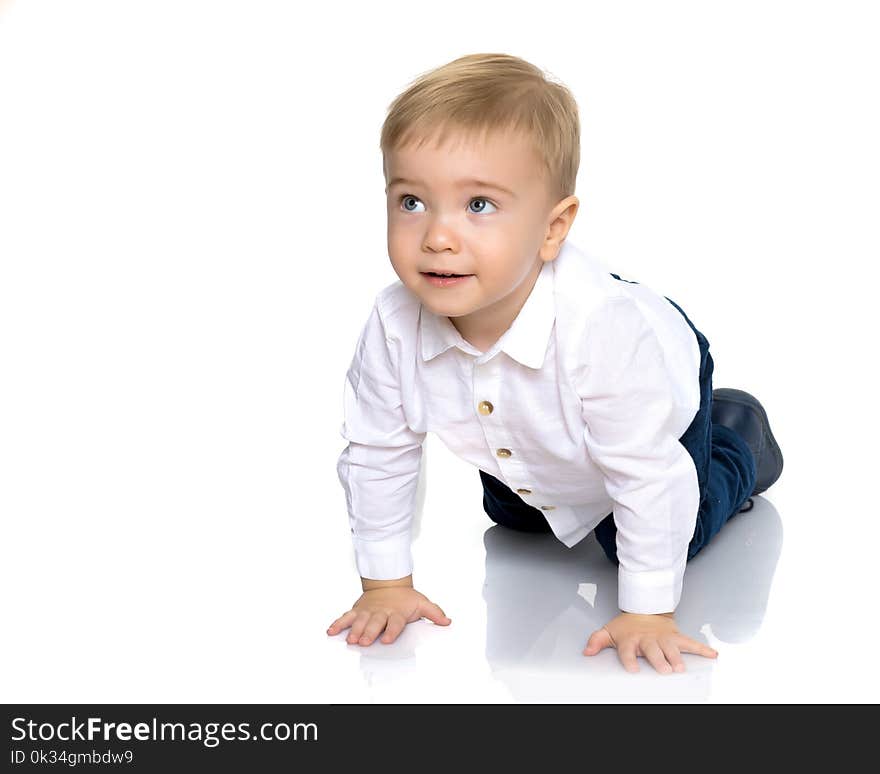 A Little Boy Is Lying On The Floor In The Studio.