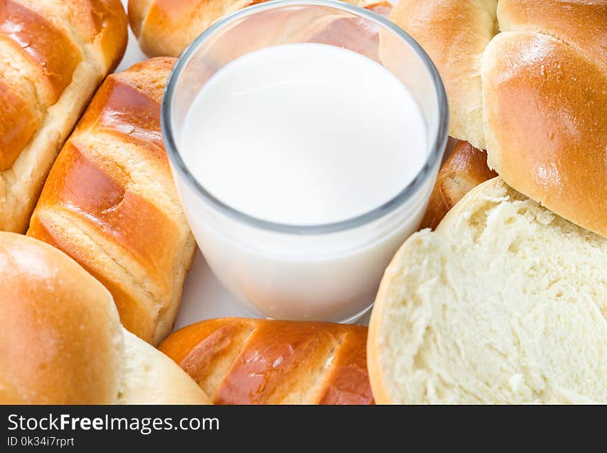 Close-up, top view, Breakfast milk and bread rolls, white background. Close-up, top view, Breakfast milk and bread rolls, white background