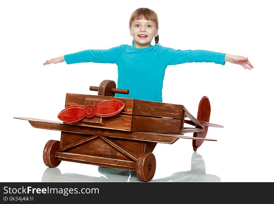 The girl is playing with a big toy airplane.