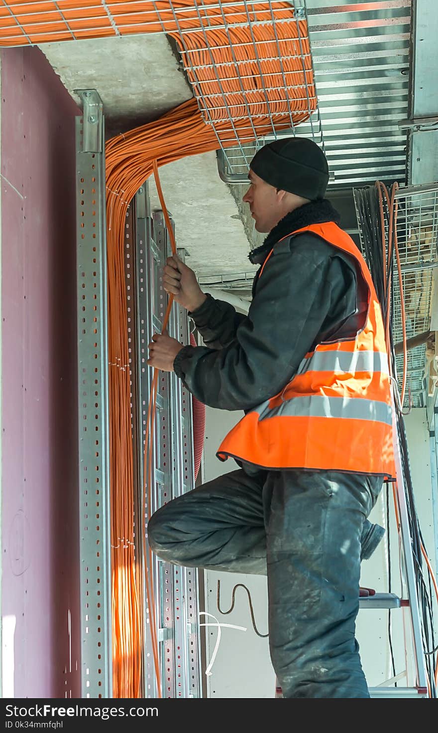 The process of fastening a yellow cable for the Internet