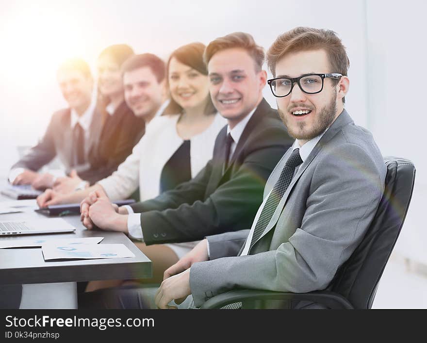 Businessman and business team sitting at Desk. Businessman and business team sitting at Desk