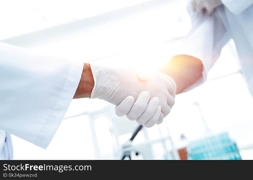 Close-up Of Two Doctor`s With Glove Shaking Hand. Close-up Of Two Doctor`s With Glove Shaking Hand