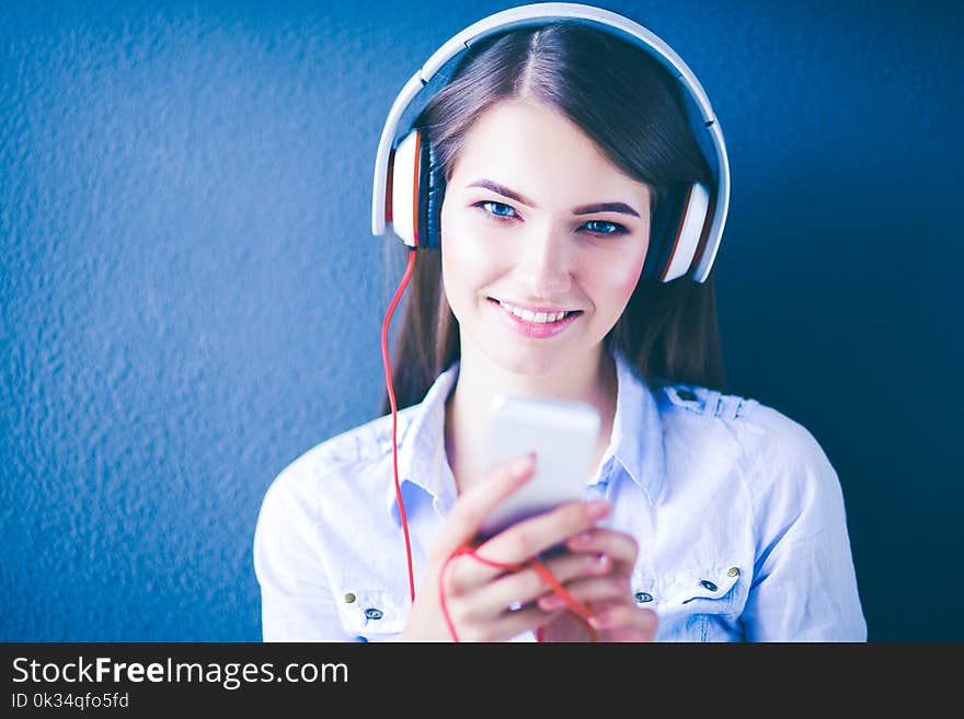 Young Happy Girl Sitting On Floor And Listening Music