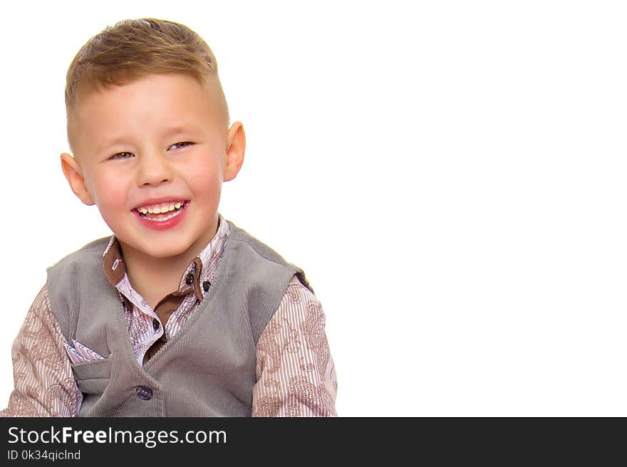 A beautiful little boy laughs fun. The concept of a happy childhood, well-being and family values. Isolated on white background. A beautiful little boy laughs fun. The concept of a happy childhood, well-being and family values. Isolated on white background.