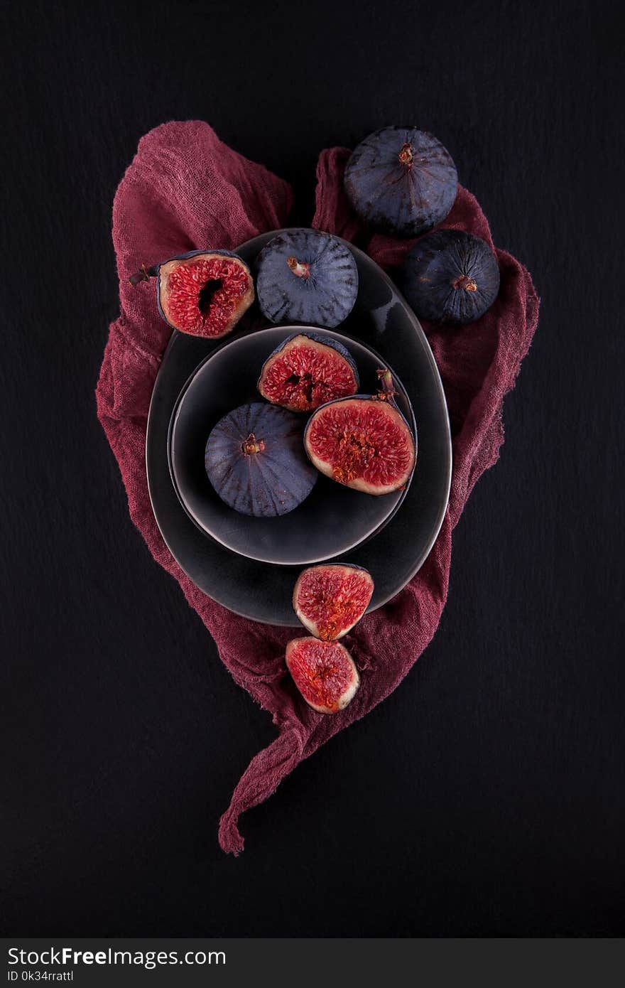 Fresh ripe figs, rustic food photography on slate plate kitchen table