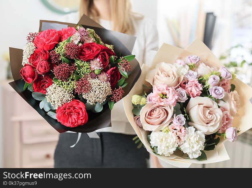 Beautiful luxury bouquet of mixed flowers in woman hand. the work of the florist at a flower shop. A small family