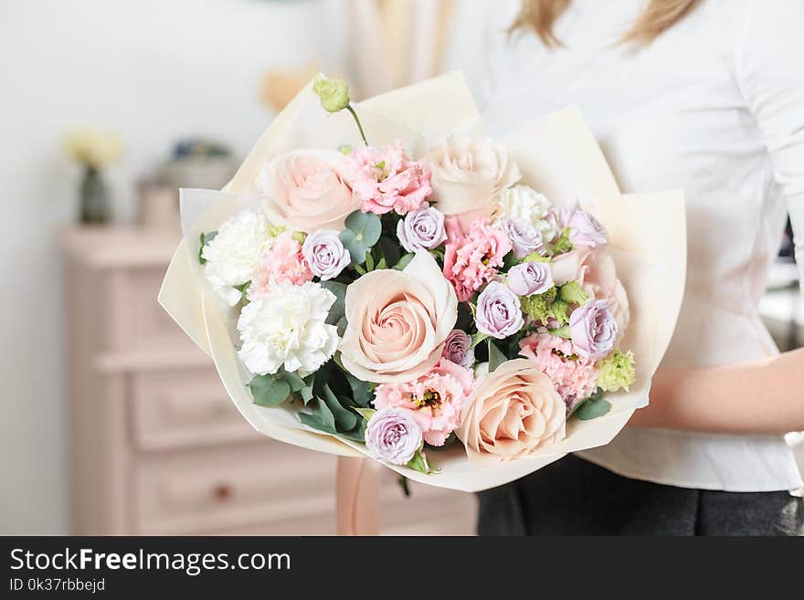 Beautiful Luxury Bouquet Of Mixed Flowers In Woman Hand. The Work Of The Florist At A Flower Shop. A Small Family