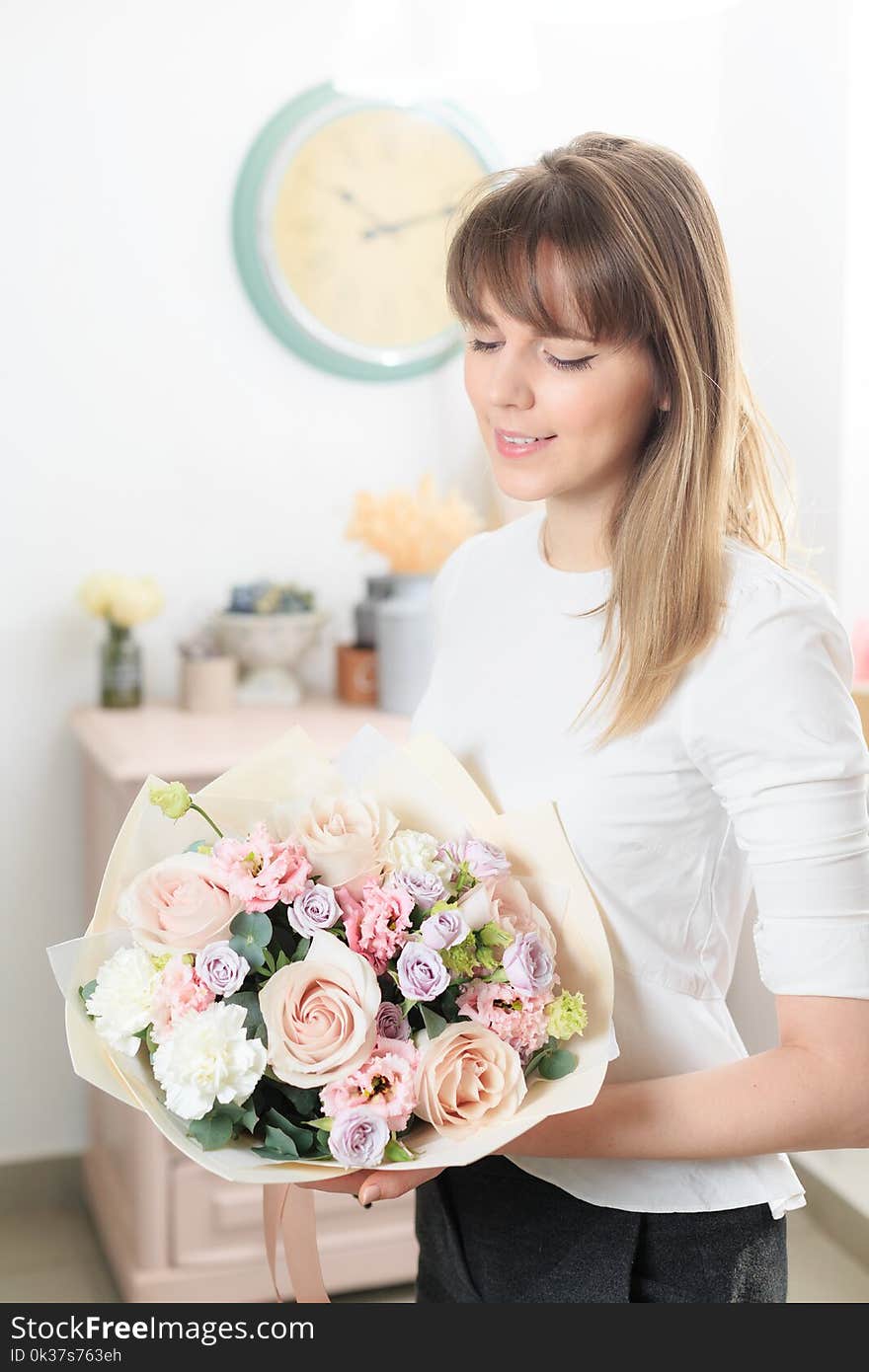 Beautiful luxury bouquet of mixed flowers in woman hand. the work of the florist at a flower shop. A small family