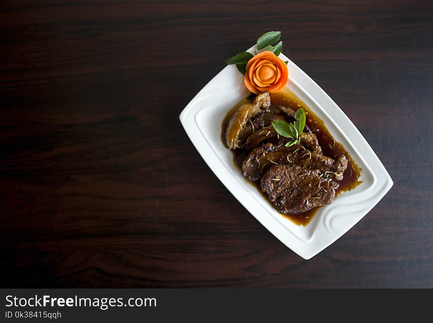 Meat With Sauce Dish on White Ceramic Plate