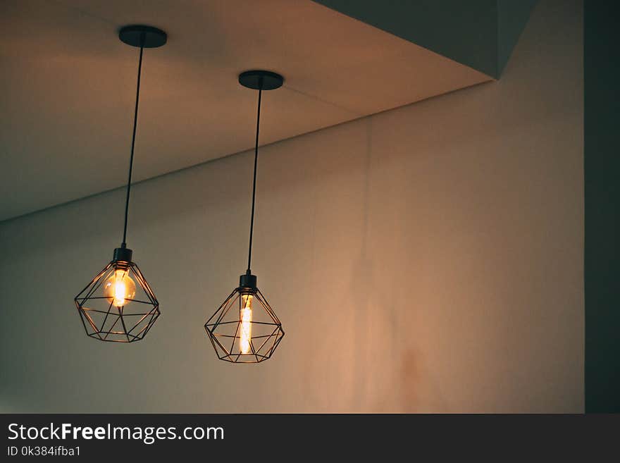 Two Black Pendant Lamp on White Concrete Ceiling