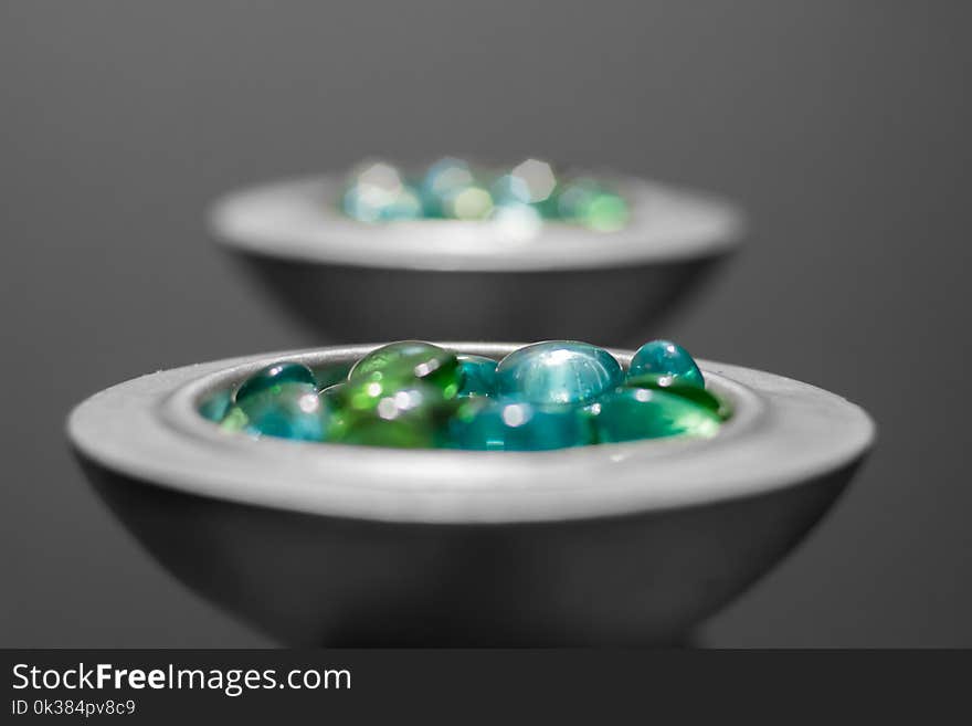 Multicolored Pebbles on White Ceramic Bowl