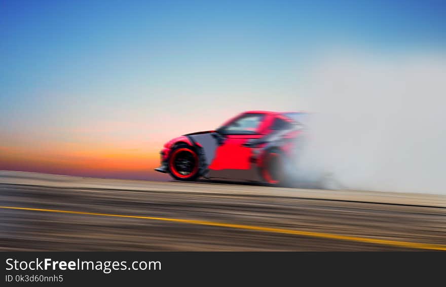 Abstract blurred car wheel drifting and smoking on track. Sport