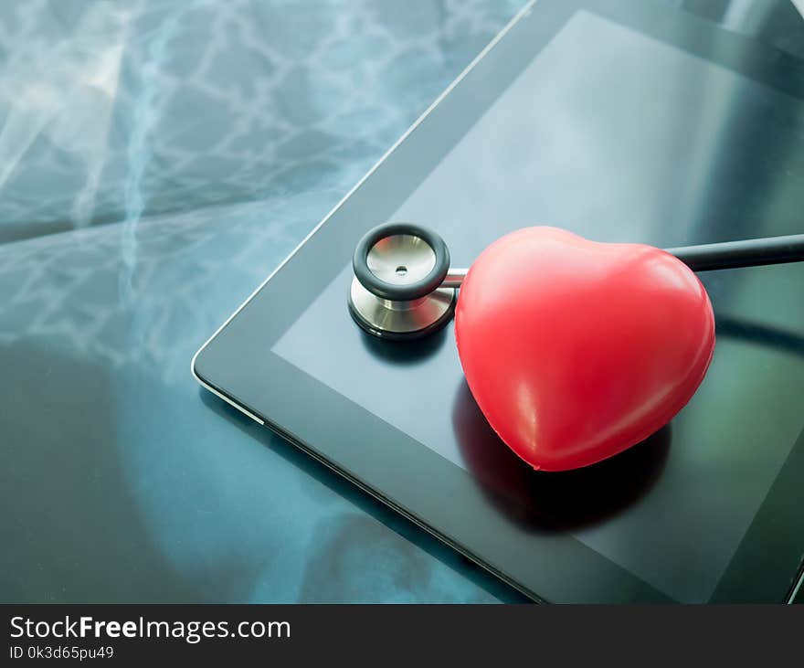 Red heart and stethoscope on Laptop. Heart disease and health care concept.