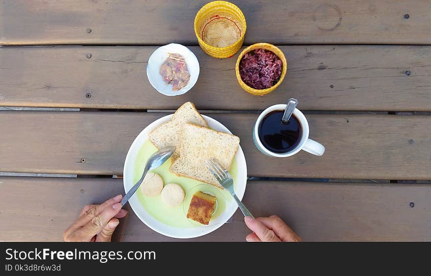 Top view man having breakfast on wooden table at home. Top view man having breakfast on wooden table at home