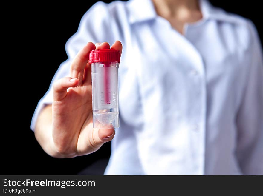 Close Of Woman Hands Holding Sterile Sample Container Bottle For Medical Analysis. Health Care And Medical Concept