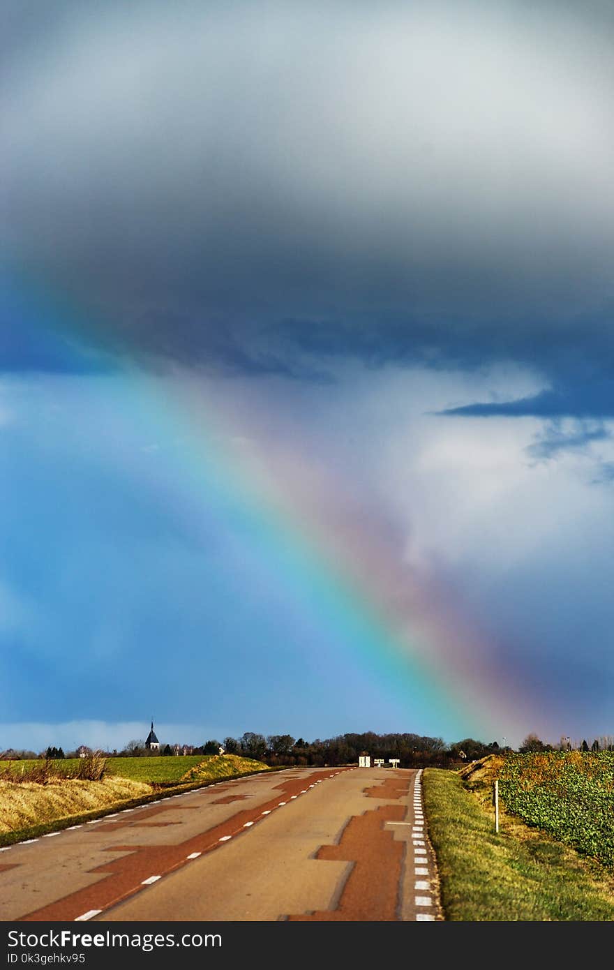 Beautiful Colorful Rainbow At The End Of Asphalt Road, Perspective View