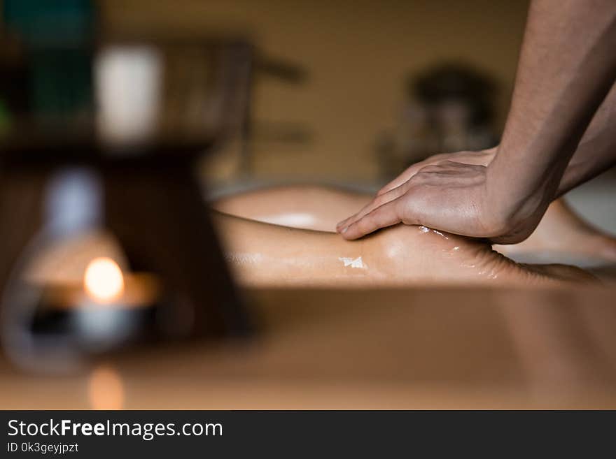 Professional Masseur Doing Deep Tissue Oiled Leg Massage to a Girl at Ayurveda Massage Session