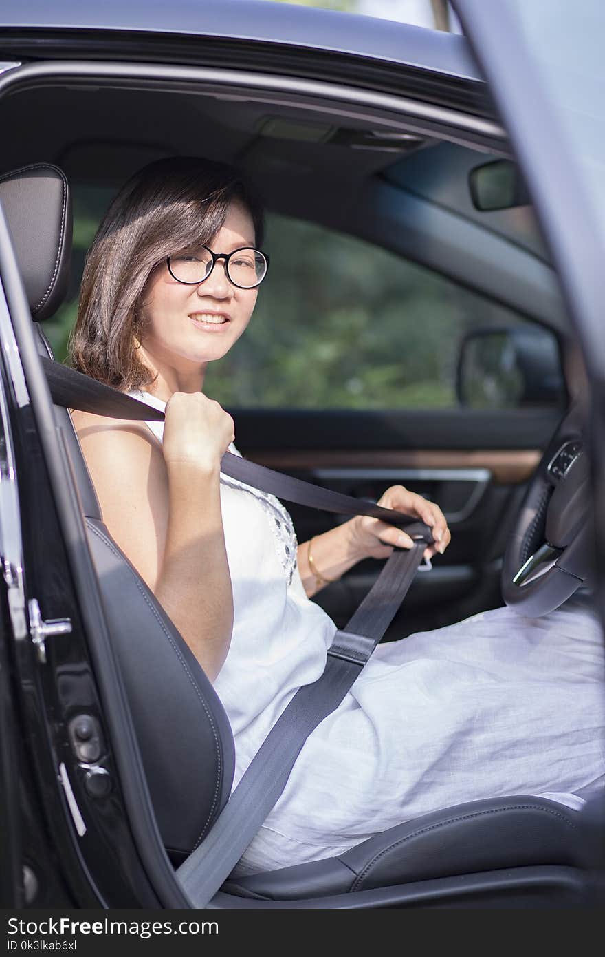 Asian woman fasten car seat belt before take a driving