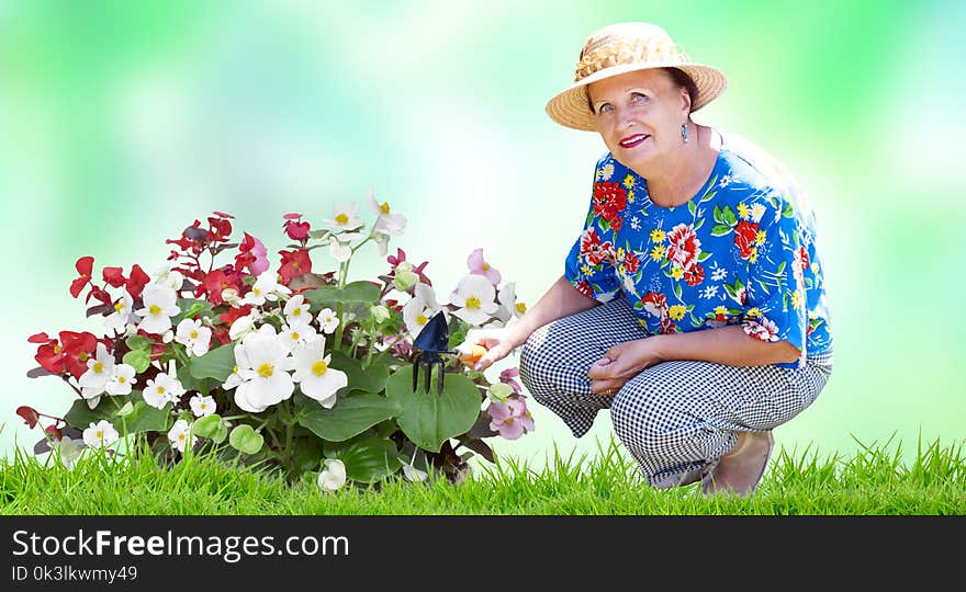 Senior woman with gardening flowers in garden