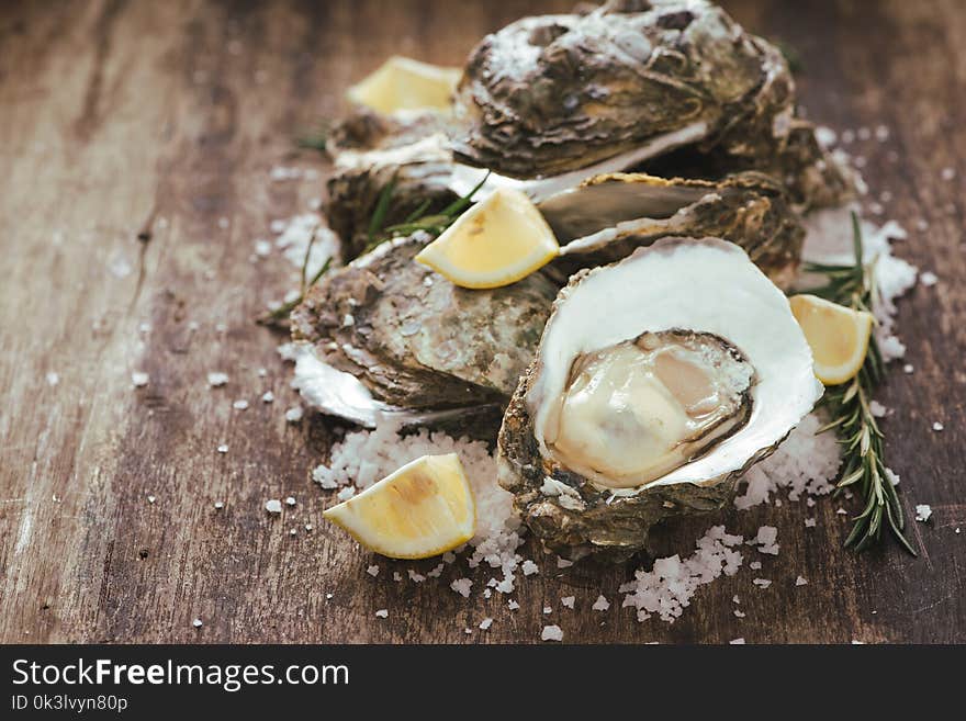 A photo of freshly opened oysters on a wooden background texture