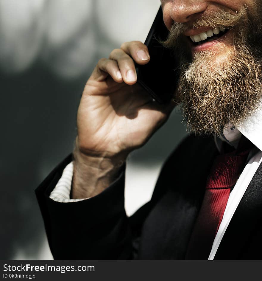 Photo of Man in Black Suit Jacket Taking a Call