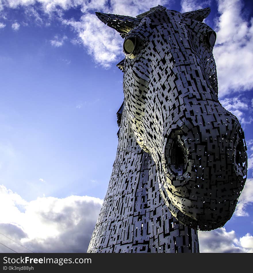 Macro Photography of Mechanical Horse Face Under White and Blue Cloudy Sky