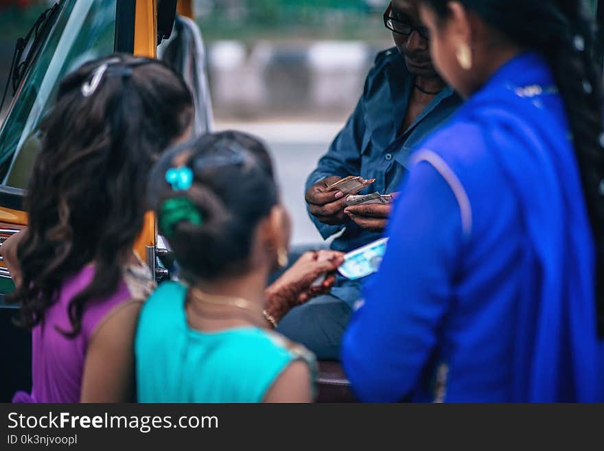 Girls Near Man Holding Money