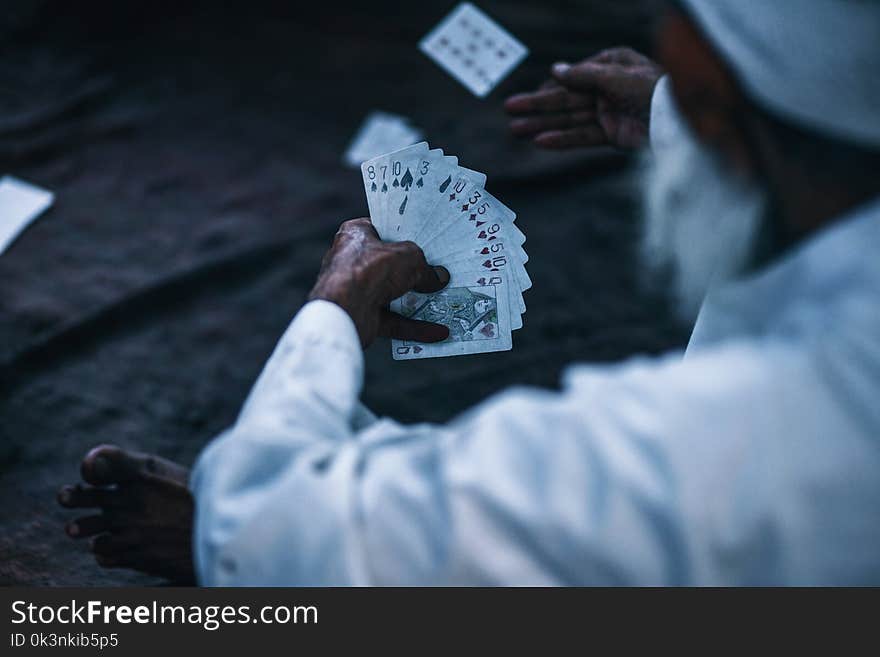 Person Holding Playing Cards