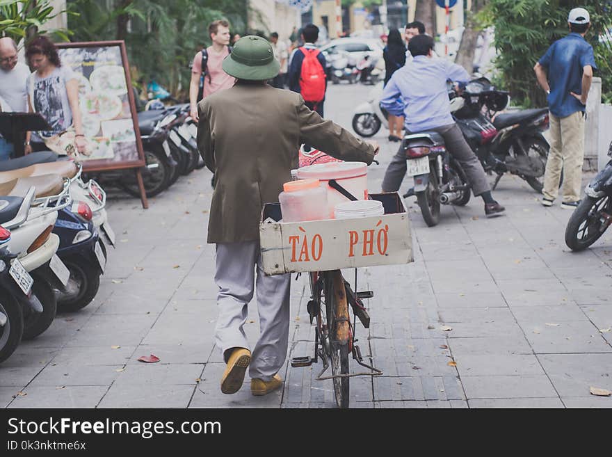 Man Walking With Bike