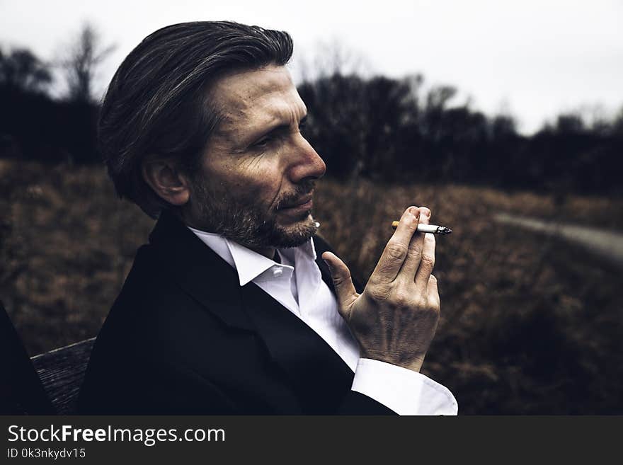 Photo of Man Holding a Cigarette