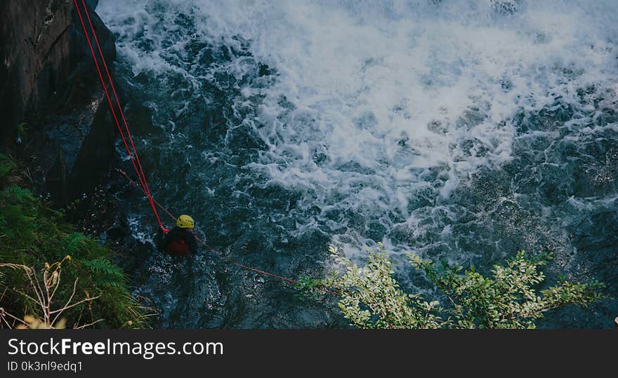 Photon of Man on Water Attached by Roof