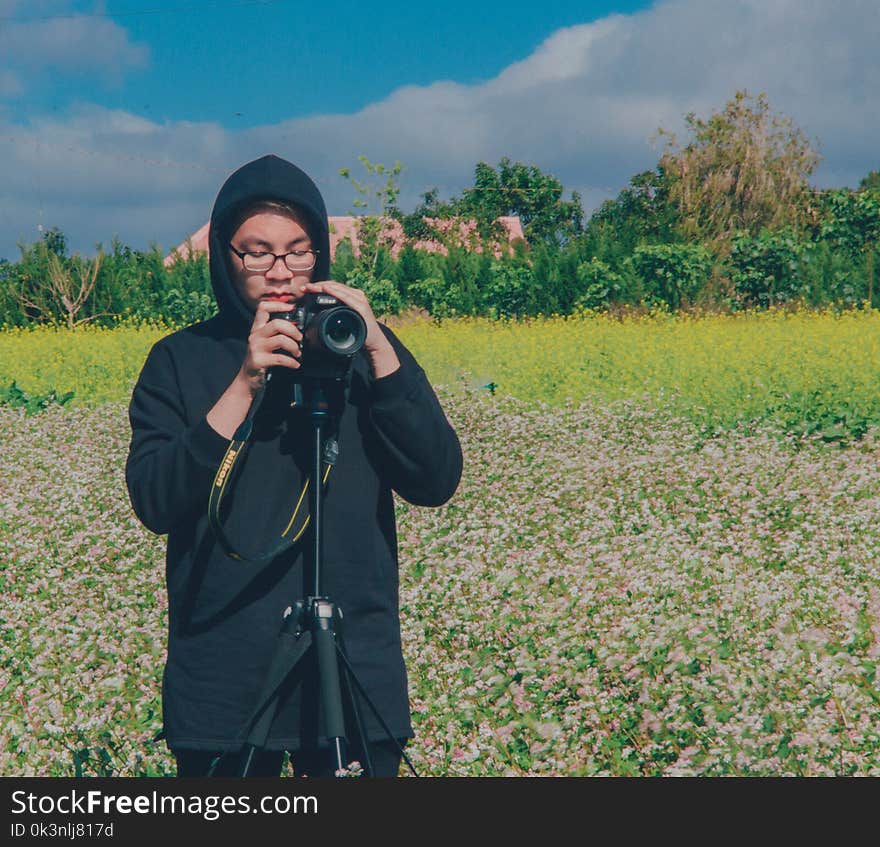 Person Holding Dslr Camera